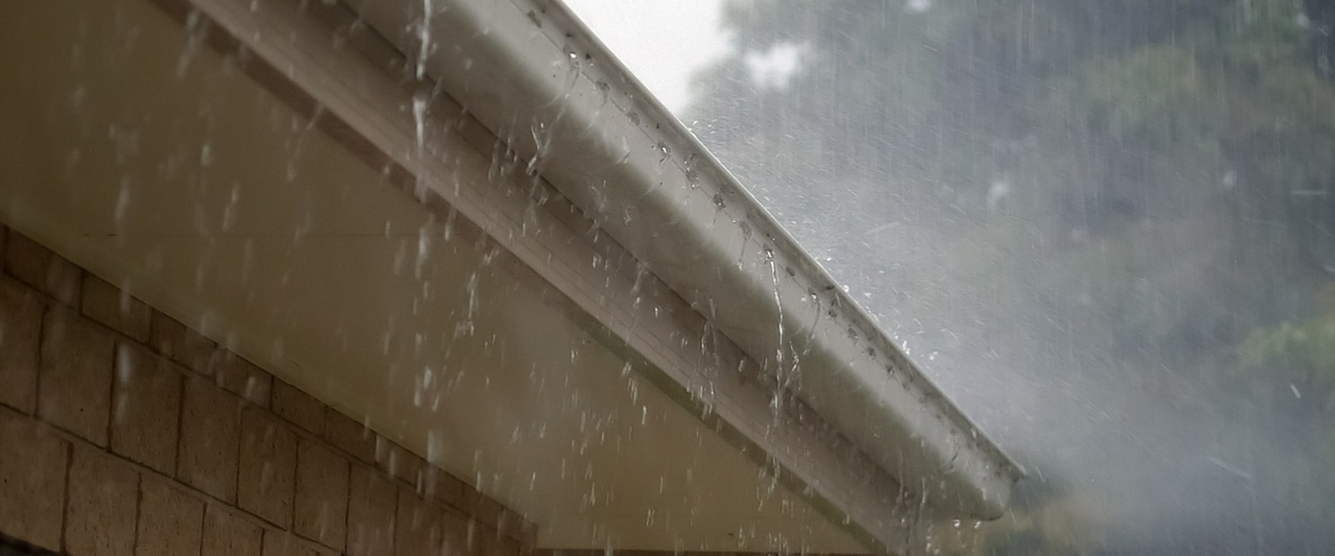 Why does rain drip behind gutters?